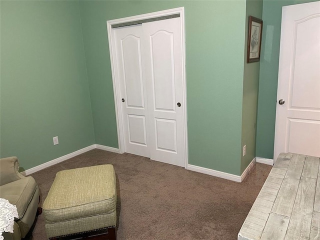 living area with dark carpet