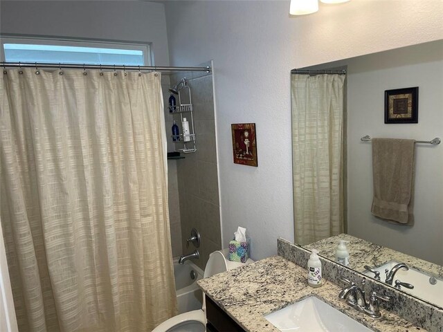 full bathroom with shower / bath combo, vanity, and toilet