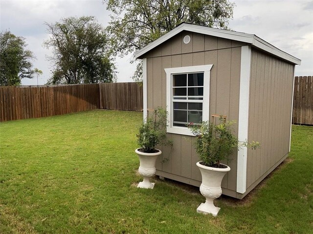 view of outbuilding with a lawn