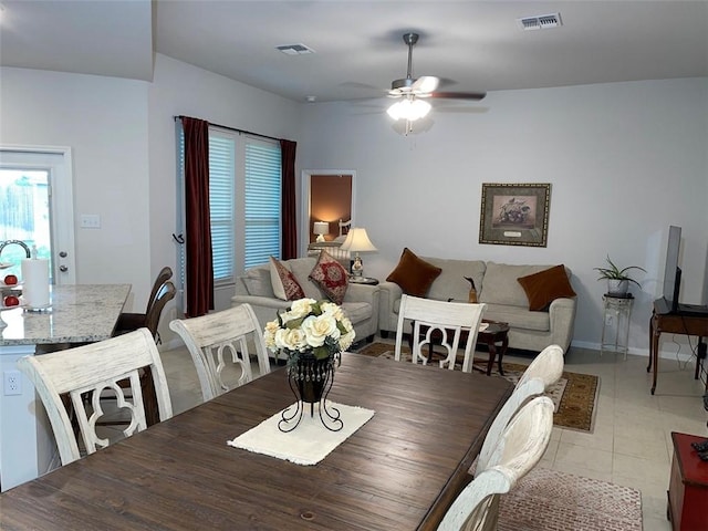 dining space featuring light tile patterned floors and ceiling fan