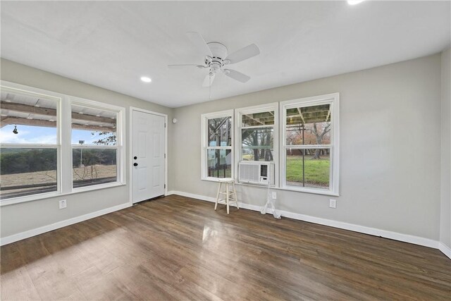 unfurnished room with dark hardwood / wood-style floors, ceiling fan, and cooling unit