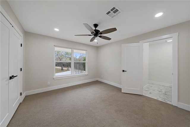 unfurnished bedroom with ceiling fan and light carpet