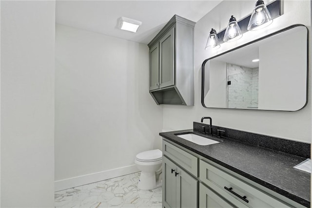 bathroom with a shower, vanity, and toilet