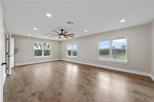 empty room featuring hardwood / wood-style floors and ceiling fan