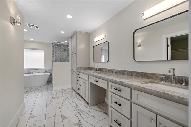 bathroom featuring shower with separate bathtub and vanity