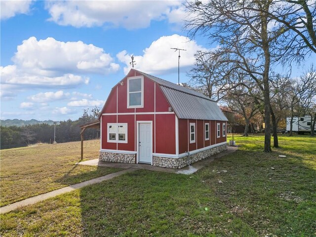 view of outbuilding with a yard