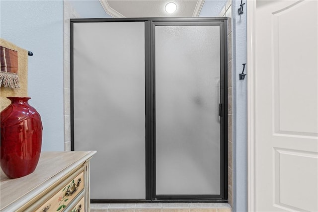 bathroom featuring vanity and a shower with door