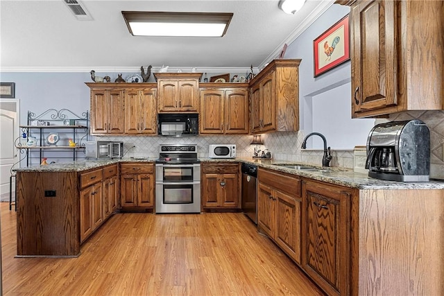 kitchen featuring light stone counters, sink, crown molding, and stainless steel appliances