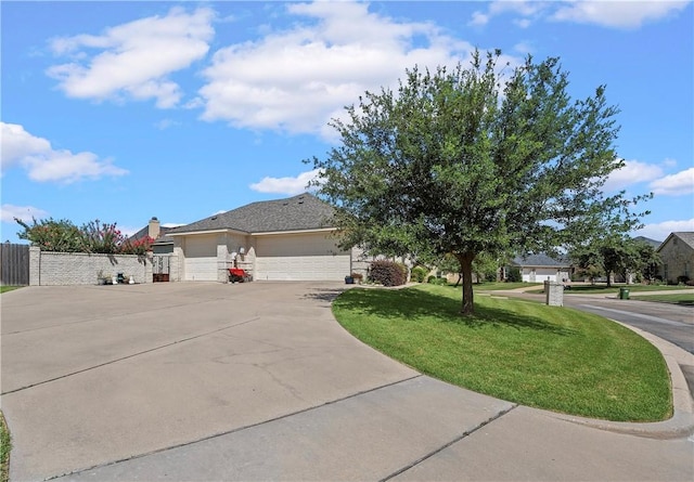 view of front of property featuring a garage and a front lawn