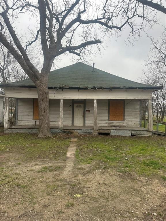 back of property featuring a porch