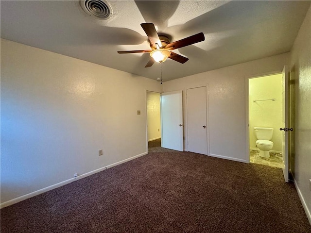 unfurnished bedroom with carpet flooring, connected bathroom, ceiling fan, and a closet