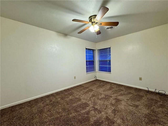 spare room featuring carpet and ceiling fan