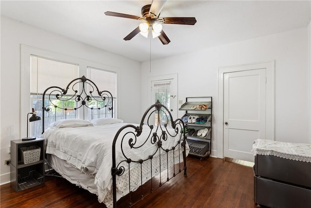 bedroom with dark hardwood / wood-style floors and ceiling fan