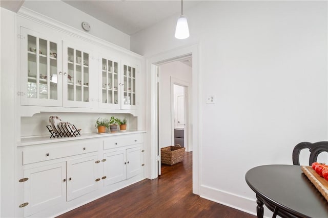 dining space with dark wood-type flooring