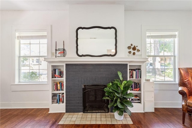 living room with dark wood-type flooring and a healthy amount of sunlight