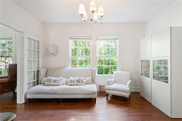 living area featuring a notable chandelier, plenty of natural light, and dark hardwood / wood-style flooring