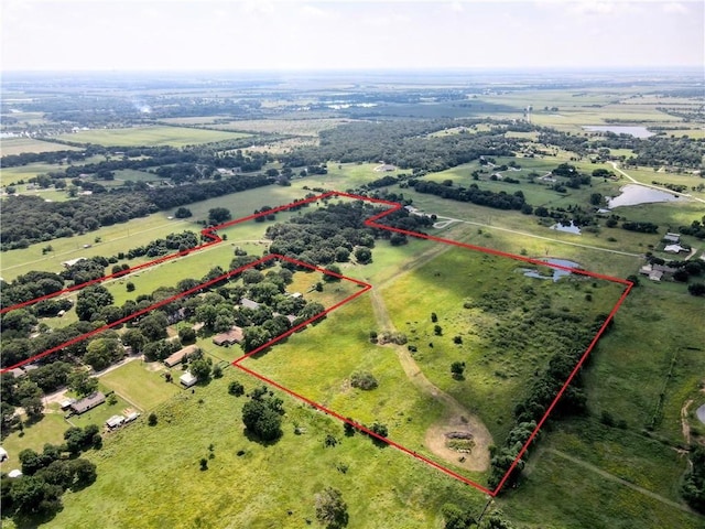 birds eye view of property featuring a rural view and a water view