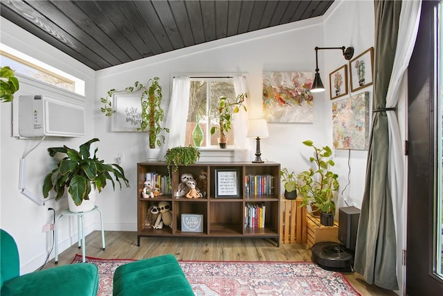 sitting room with lofted ceiling, wooden ceiling, and a healthy amount of sunlight