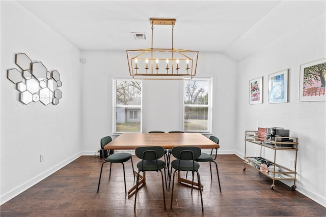 dining area featuring baseboards, visible vents, lofted ceiling, dark wood-type flooring, and an inviting chandelier