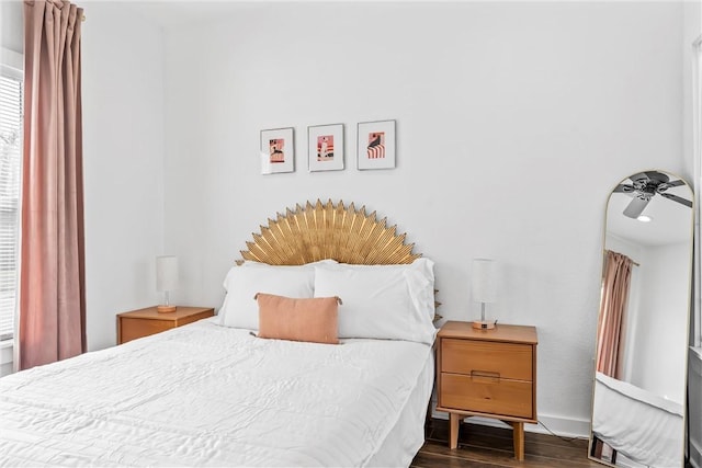 bedroom featuring baseboards and wood finished floors