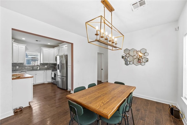 dining room with baseboards, visible vents, dark wood-type flooring, and recessed lighting