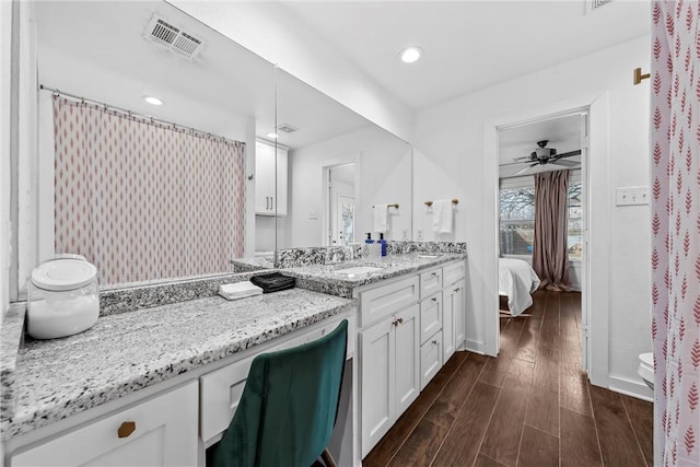 bathroom with ensuite bathroom, ceiling fan, wood finished floors, vanity, and visible vents