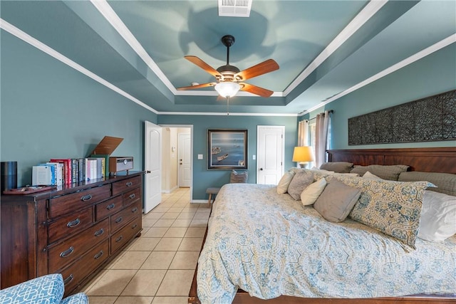 bedroom with crown molding, light tile patterned floors, a raised ceiling, a closet, and ceiling fan