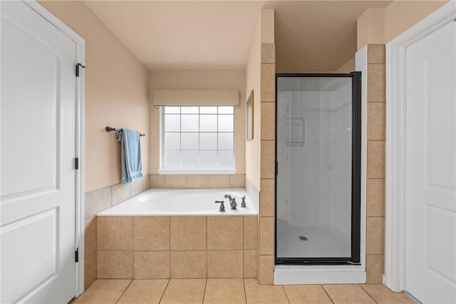 bathroom featuring tile patterned flooring and shower with separate bathtub