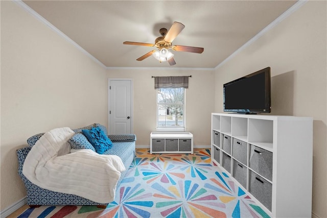 living area featuring ornamental molding and ceiling fan