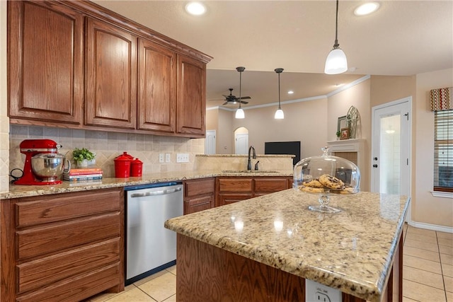 kitchen with sink, light tile patterned floors, backsplash, hanging light fixtures, and stainless steel dishwasher