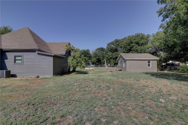 view of yard with an outbuilding and central AC