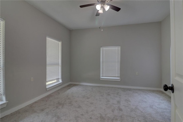 empty room with light colored carpet and ceiling fan