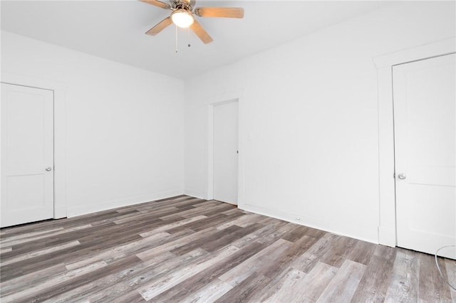 empty room with wood-type flooring and ceiling fan