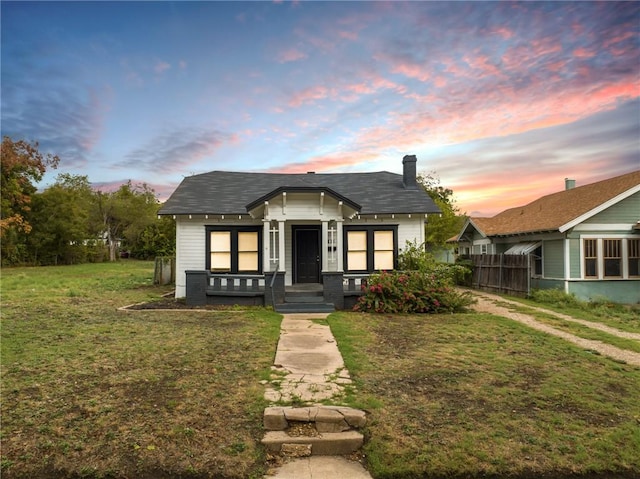 bungalow-style house featuring a lawn