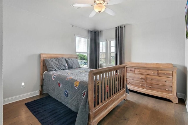 bedroom with ceiling fan and dark wood-type flooring