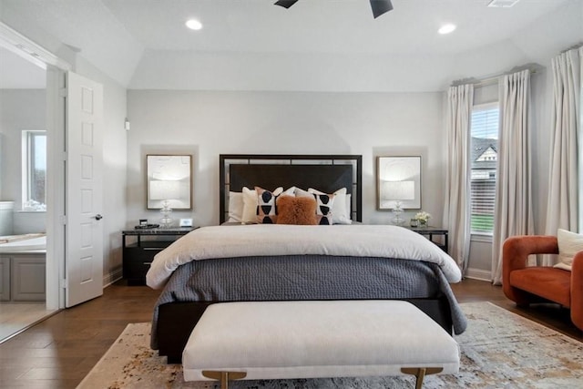 bedroom featuring ensuite bathroom, ceiling fan, and dark wood-type flooring