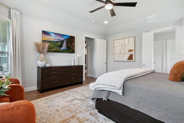 bedroom with dark hardwood / wood-style floors and ceiling fan