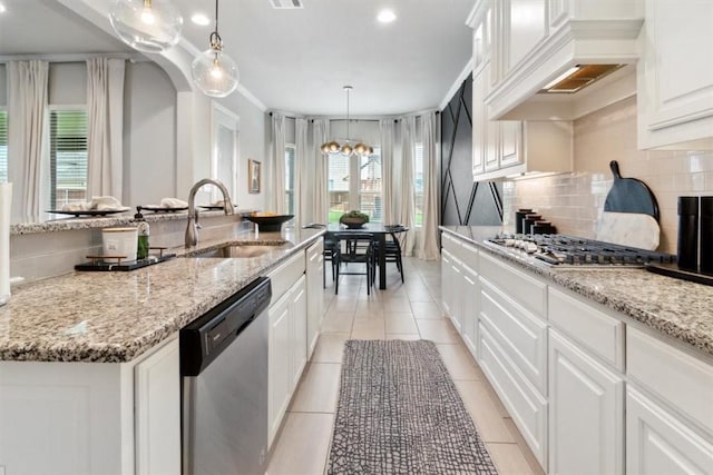 kitchen featuring sink, a kitchen island with sink, stainless steel appliances, decorative backsplash, and white cabinets