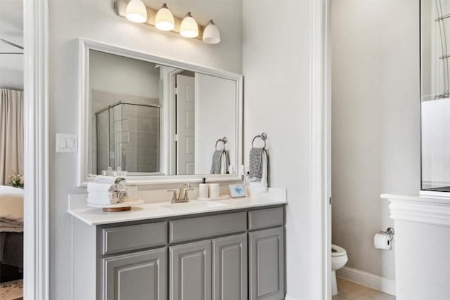 bathroom with toilet, vanity, and walk in shower