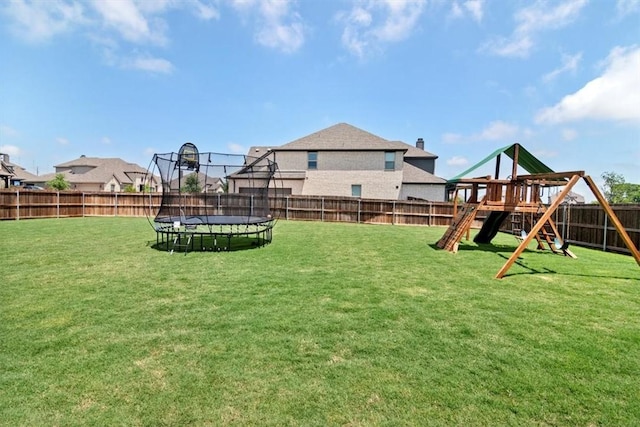 view of yard featuring a playground and a trampoline