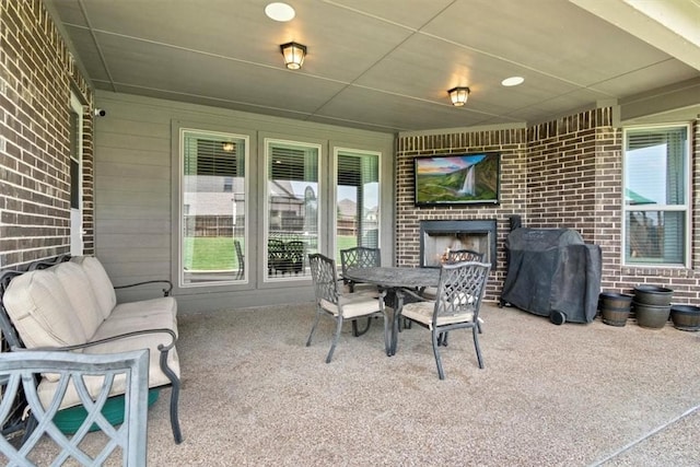 view of patio / terrace featuring an outdoor living space with a fireplace and grilling area