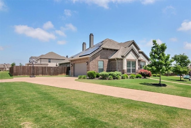 view of front of house featuring solar panels and a front yard