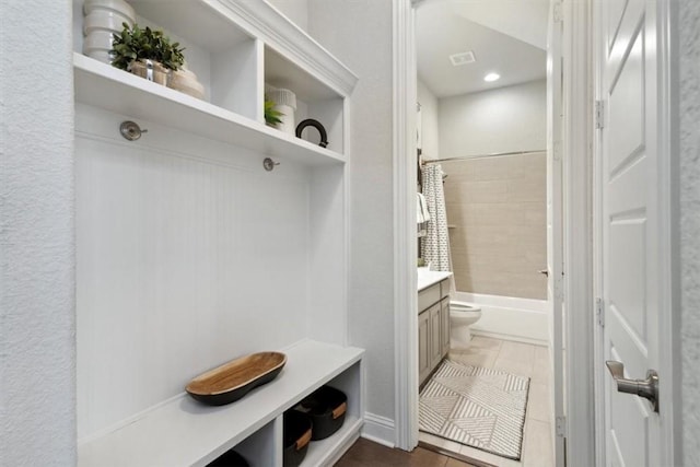 mudroom featuring dark tile patterned flooring