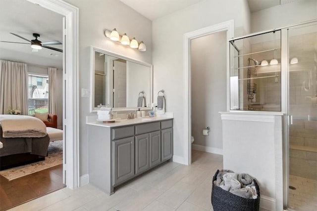 bathroom with vanity, tile patterned floors, ceiling fan, toilet, and a shower with shower door