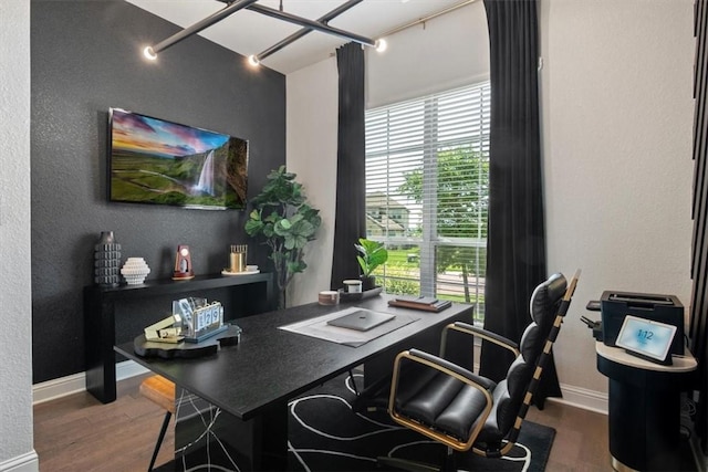 office space with a chandelier, dark hardwood / wood-style flooring, track lighting, and plenty of natural light