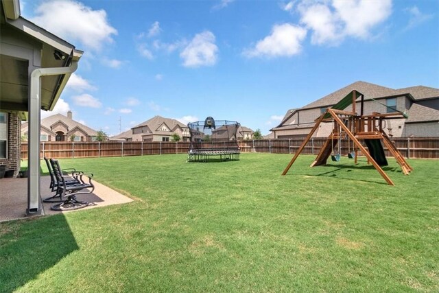 view of yard featuring a playground, a trampoline, and a patio area