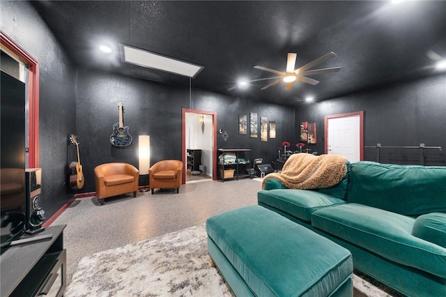 living room featuring recessed lighting, a textured wall, ceiling fan, and speckled floor