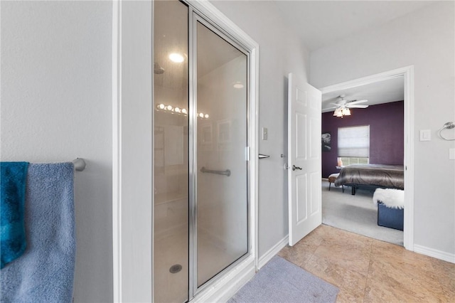 bathroom featuring ceiling fan and an enclosed shower