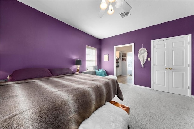 bedroom with light colored carpet, visible vents, a ceiling fan, connected bathroom, and baseboards