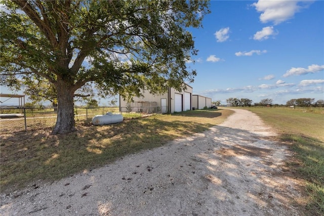 exterior space featuring a garage and fence